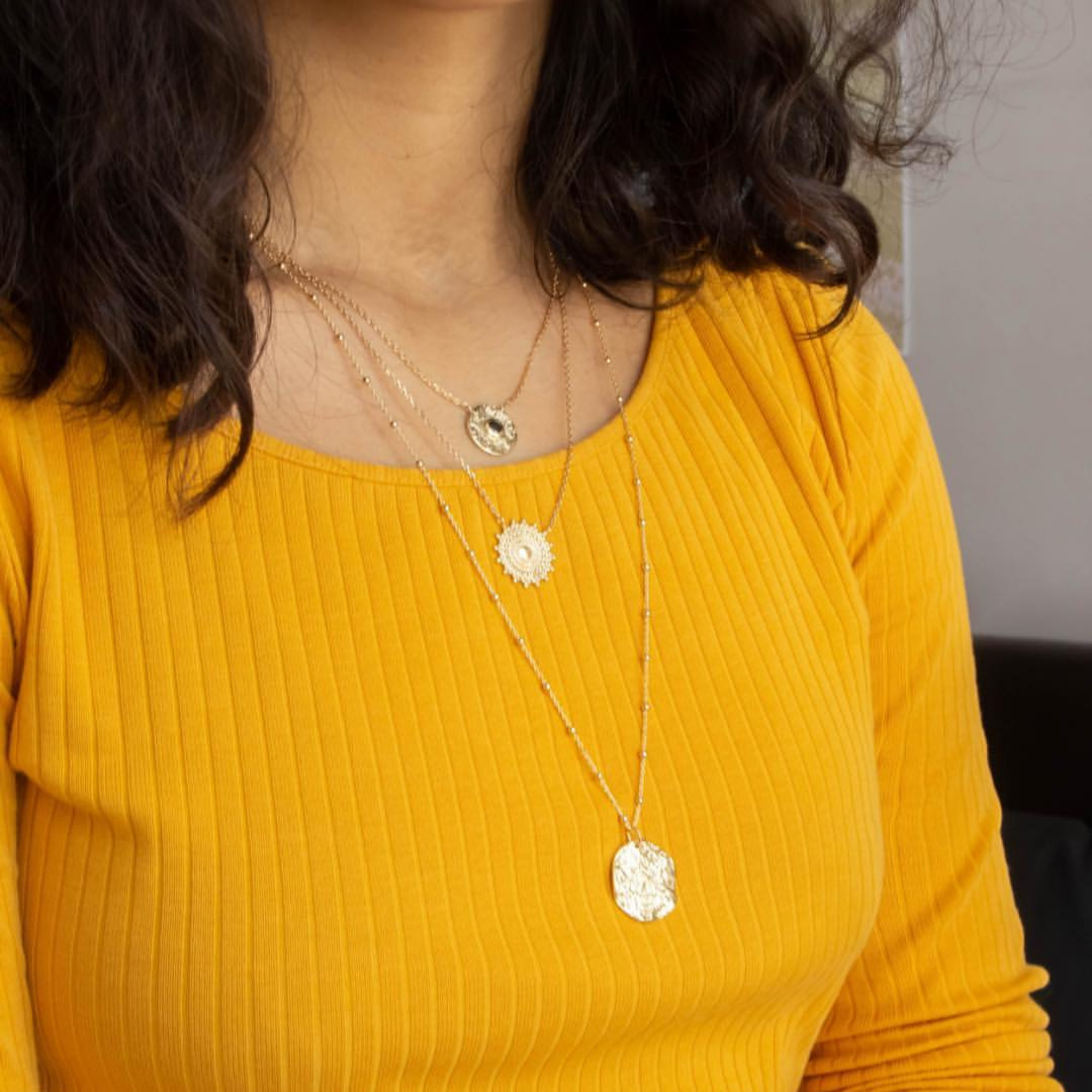 gold-plated moon necklace worn with two other necklaces