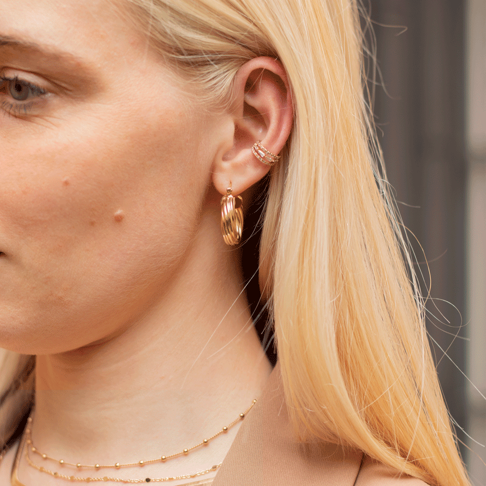 Worn twisted hoop earrings 