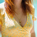 gold-plated sun necklace worn