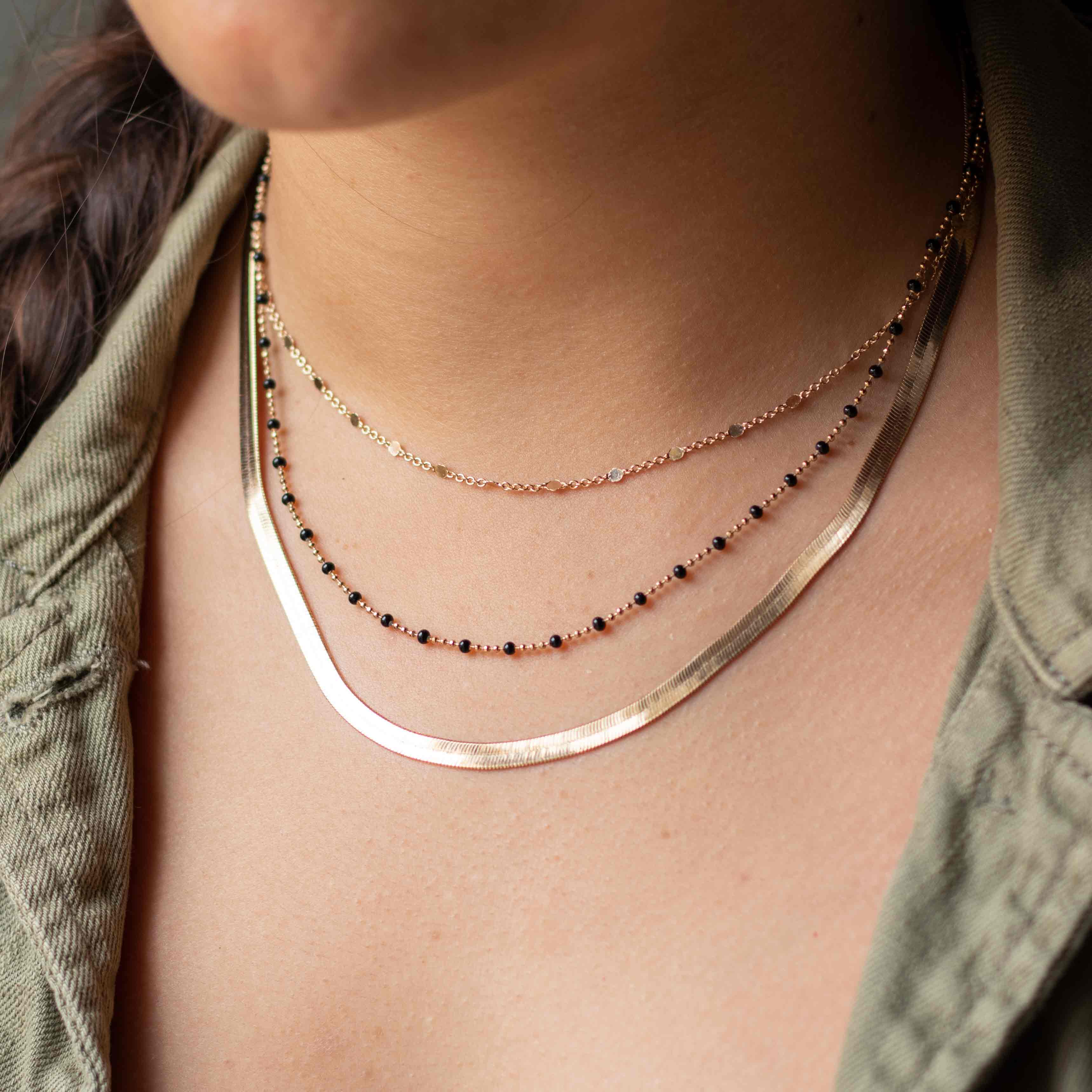 gold-plated black pearl necklace worn